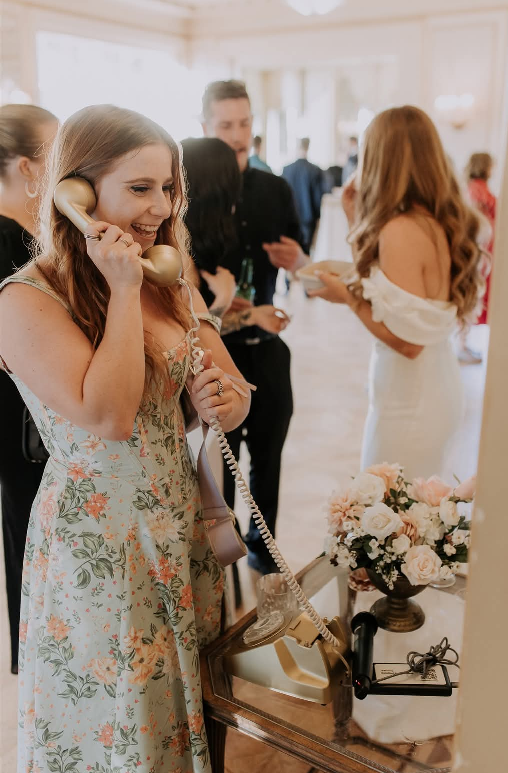 Guest using the vintage phone booth feature inside the venue